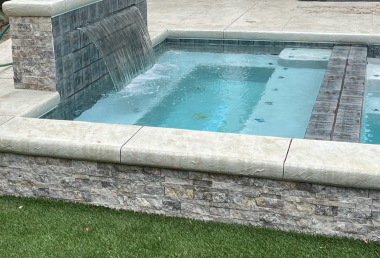 A sheer descent flows into a hot tub.